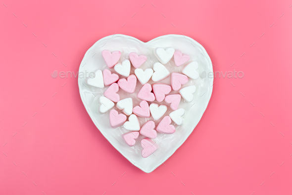 Heart shaped plate with heart shaped marshmallows, flat lay. Stock Photo by  puhimec