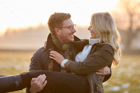 guy carrying girl in arms romantic
