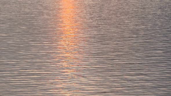 Natural Water Surface Texture Made in the Evening or Morning with Sun Reflection on Waves