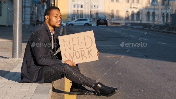 Sad desperate frustrated ethnic employee office worker African American man male guy sitting on