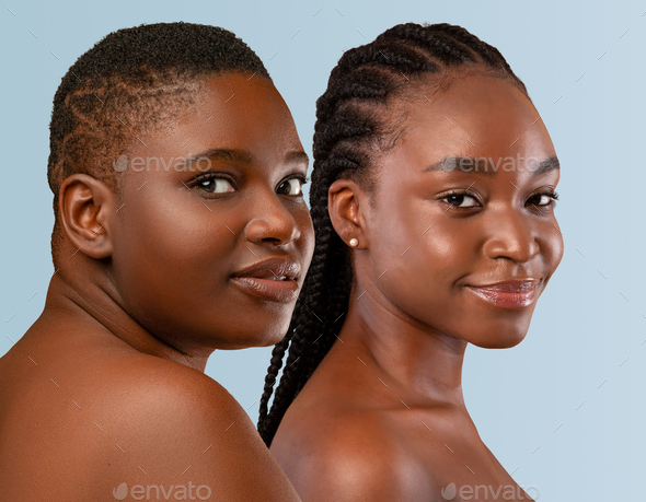 Half-naked young black women posing on studio background Stock Photo by