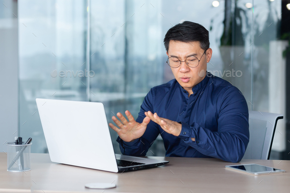 Man panic attack at work, office worker worried breathing hard, asian man depressed and sad