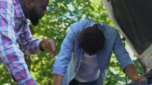 Anxious Male Giving Slap Upside Head to Son, Trying to Repair Auto, Teacher alt