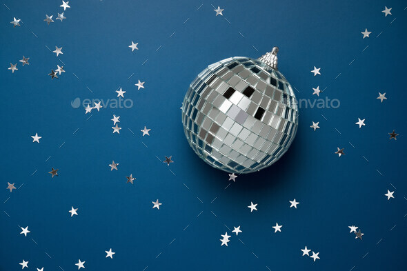 disco ball on blue background with silver stars