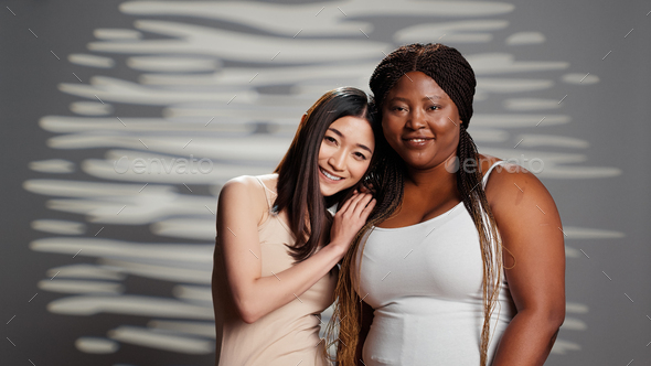 Interracial ladies being glamorous posing for skincare ad