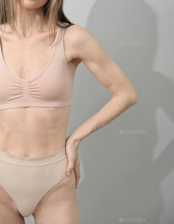 unrecognizable woman wearing underwear, authentic unretouched skin, natural beauty, no filter - Stock Photo - Images