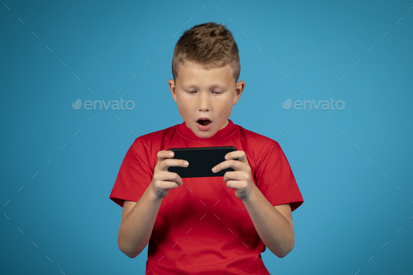 Boys are enjoying playing online games in their mobile phones