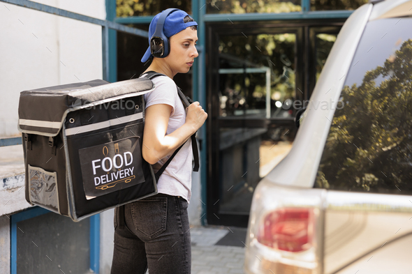 Courier with thermal bag delivering food order by car
