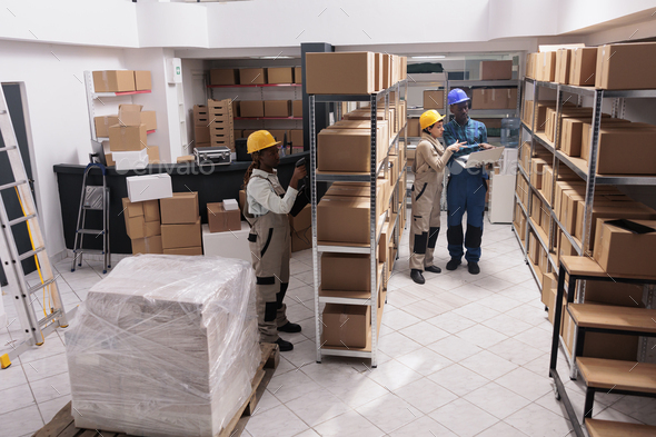 Delivery service warehouse managers preparing customer order before dispatching