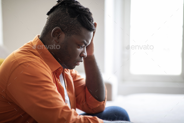 Side View Of A Thoughtful Black Man Stock Photo, Picture and