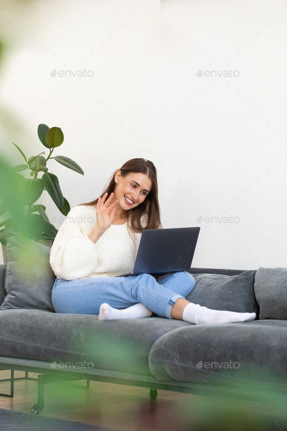 A Comfy Couch With Pillows Surrounded By Houseplants Stock Photo