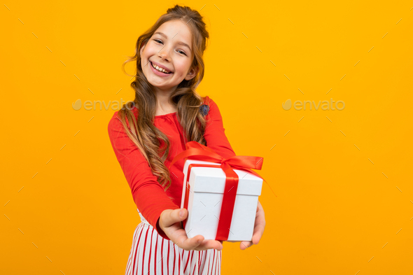 smiling beautiful caucasian girl holds out a box with a birthday ...