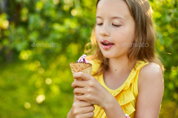 Happy girl with braces eating italian ice cream cone smiling while ...