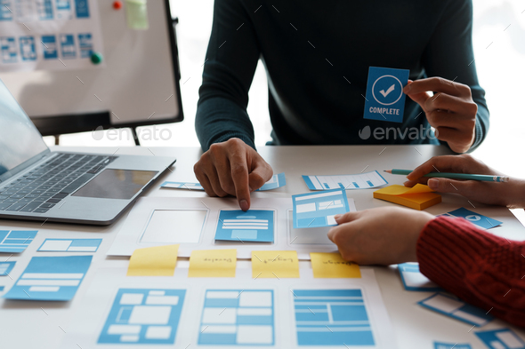 Designer, programmers, developers of mobile applications work together ...