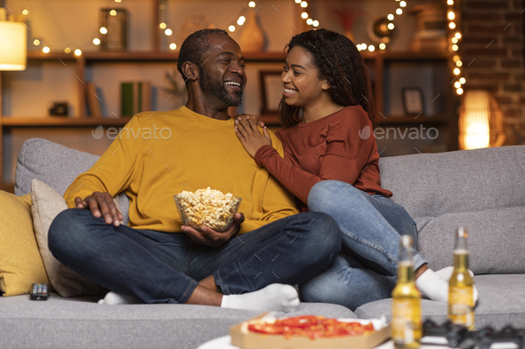 Loving black husband and wife chilling at home