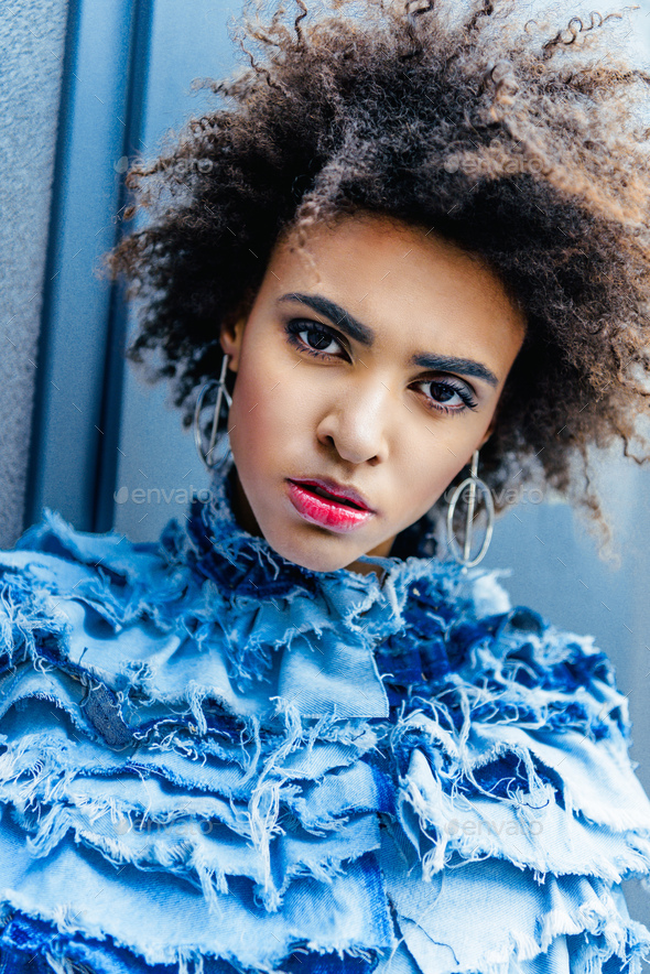 portrait of afro girl in blue clothes posing for fashion shoot Stock ...