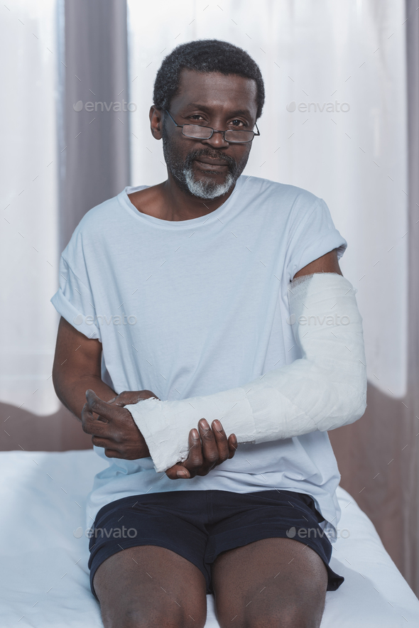 African american patient with broken arm in plaster cast