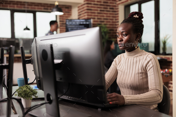 African american tech enginner typing big data code on computer
