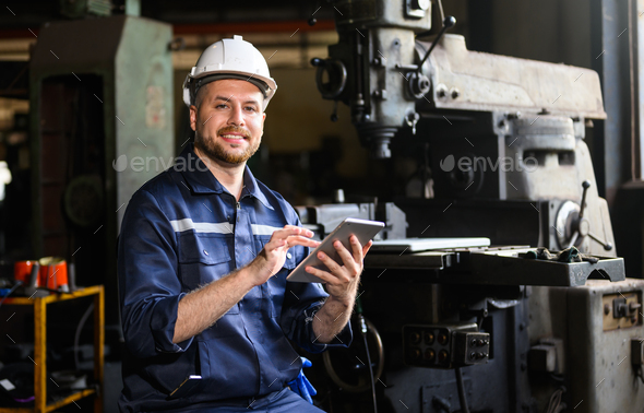 Professional male technician engineer using tablet checking machine