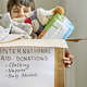 Happy kid supporting a box with humanitarian aid for a natural disaster victims - PhotoDune Item for Sale
