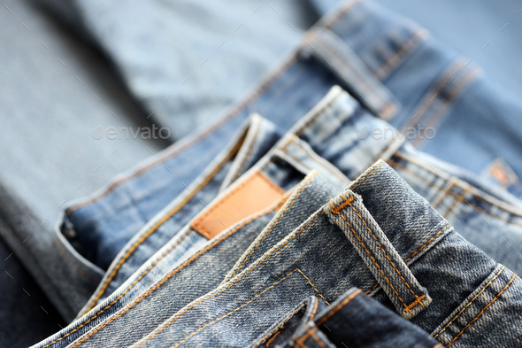 Many jeans in stack in wardrobe room - Stock Photo - Images