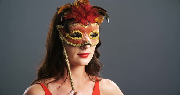 Portrait of beautiful woman wearing masquerade mask 4k alt