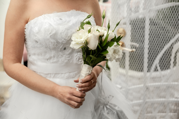 Bride holding bouquet of white flowers on Wedding day - Stock Photo - Images