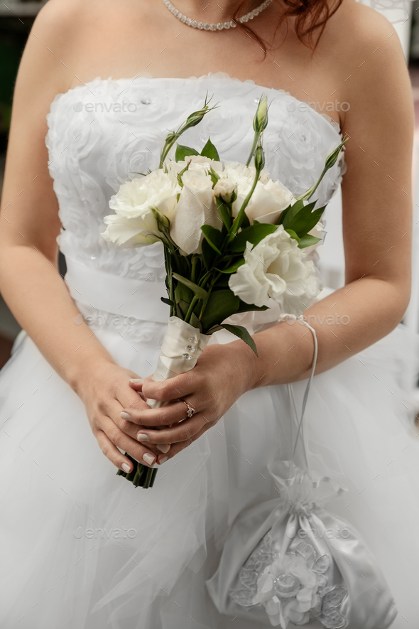 Closeup portrait of bride holding bouguet of white flowers on wedding day - Stock Photo - Images