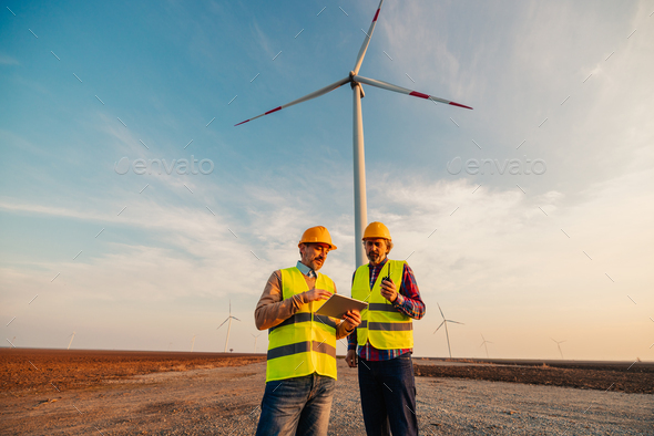 Wind Turbine middle age mechanical engineers working outdoors