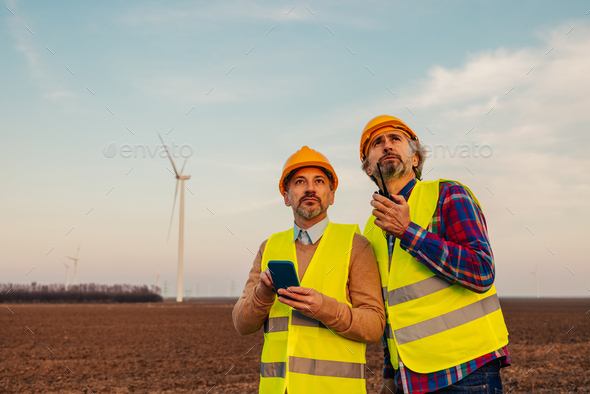 Two engineers at windmill field - Stock Photo - Images