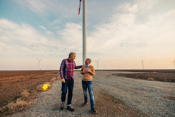 Two wind engineers at a wind farm. - Stock Photo - Images