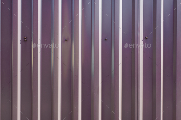 Brown metal profile fence outdoors, close-up. Building material metal tile or corrugated profiled