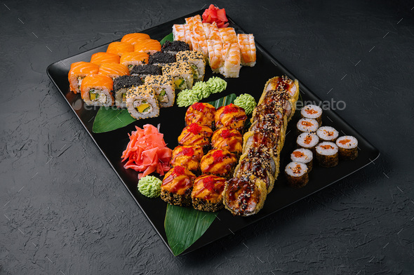 Japanese Sushi Set. Sashimi, Maki Rolls. On Plate Over Stone