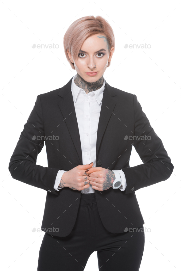 tattooed businesswoman with pink hair posing in suit, isolated on white