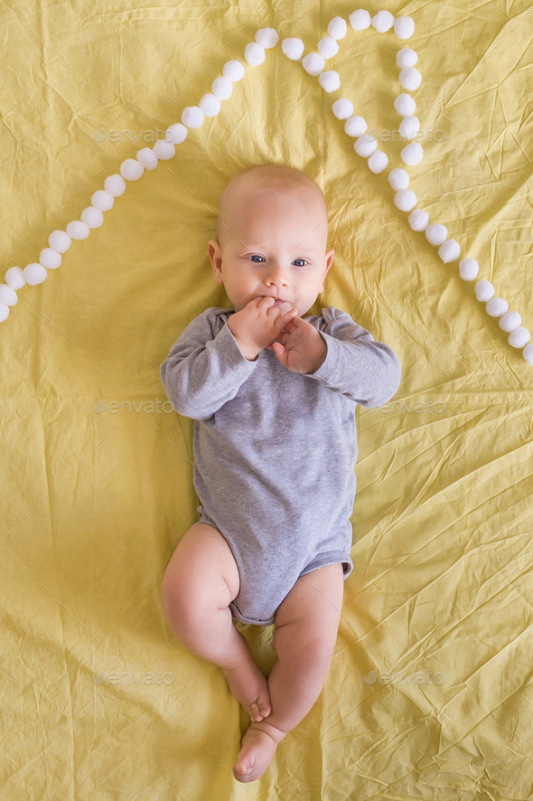 top view of beautiful infant child under house roof made of cotton