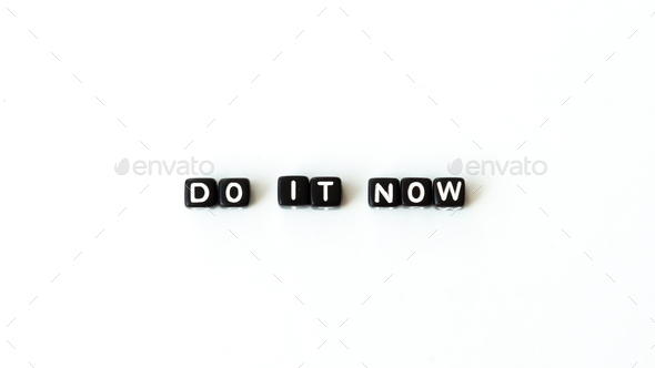 Do it now motivation quote in black letter beads on white background. Top view. Mock up copy space