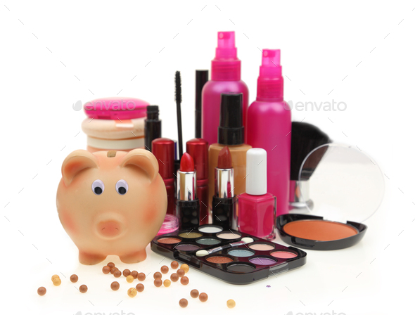 Piggy bank with various cosmetics isolated on white background