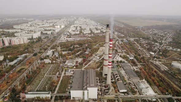 Aerial View of the High Pipes of the Thermal Power Plant Near the Modern City alt