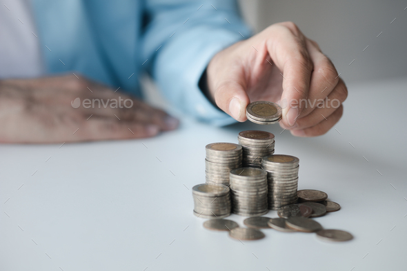 Person with stack of coins, saving money concept for future use and financial stability, savings for