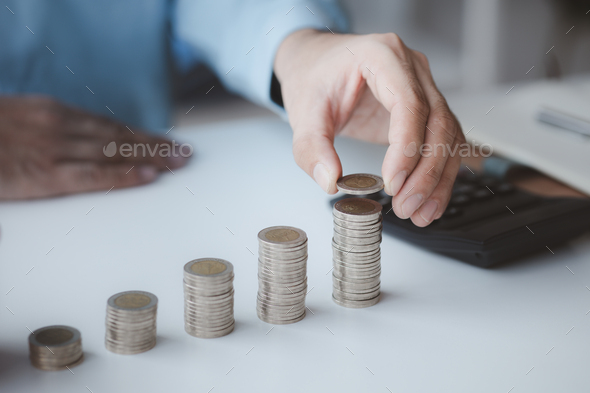 Person with pile of coins and piggy bank, money saving concept for future use and financial stabilit