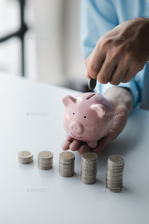 Person with pile of coins and piggy bank, money saving concept for future use and financial stabilit