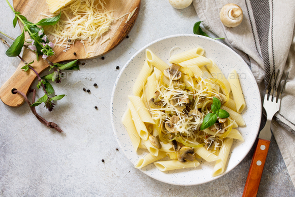 Pasta Penne with mushrooms and cheese on stone table. Vegetarian ...