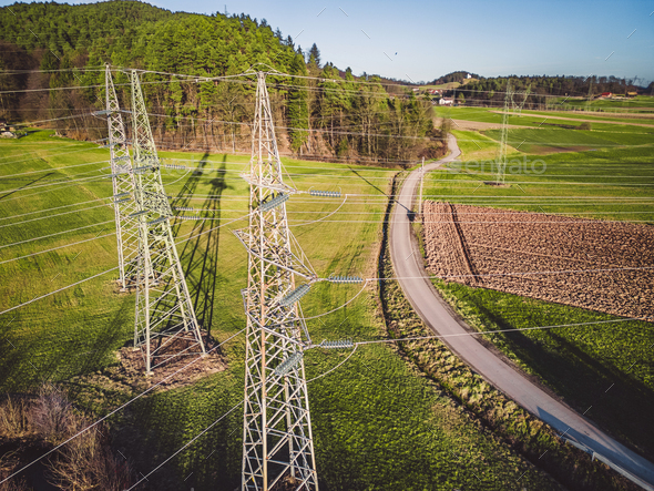 Drone view of three electrical power towers in the countryside