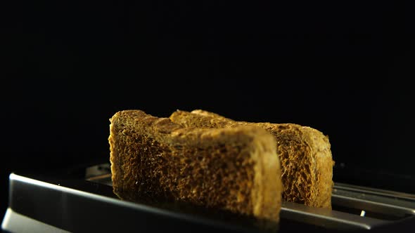 Golden roasted toast flying in slow motion from the toaster