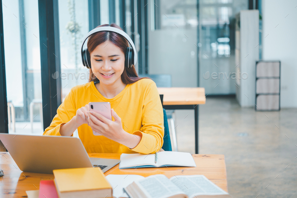 young student wearing headphones studies online, distance learning Stock Photo by photobyphotoboy