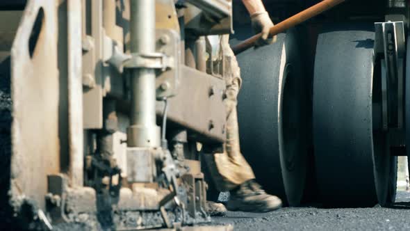 Wheels of an Asphalt-placing Vehicles in a Front View. Road Construction Process. alt