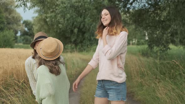 Family Mother and Daughters Walking Together Along Country Road alt