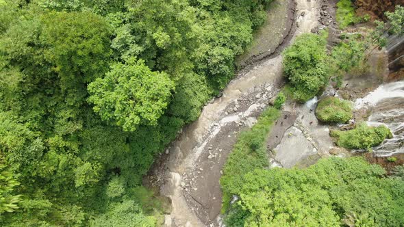 Aerial view of the river and streams in mountain gorge tropical forest. alt