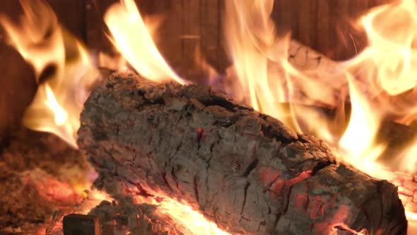 Flame of Fire in Darkness Burning Wood on Fireplace alt