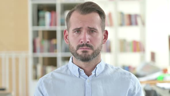 Portrait of Sad Young Man Looking At Camera, Upset  alt